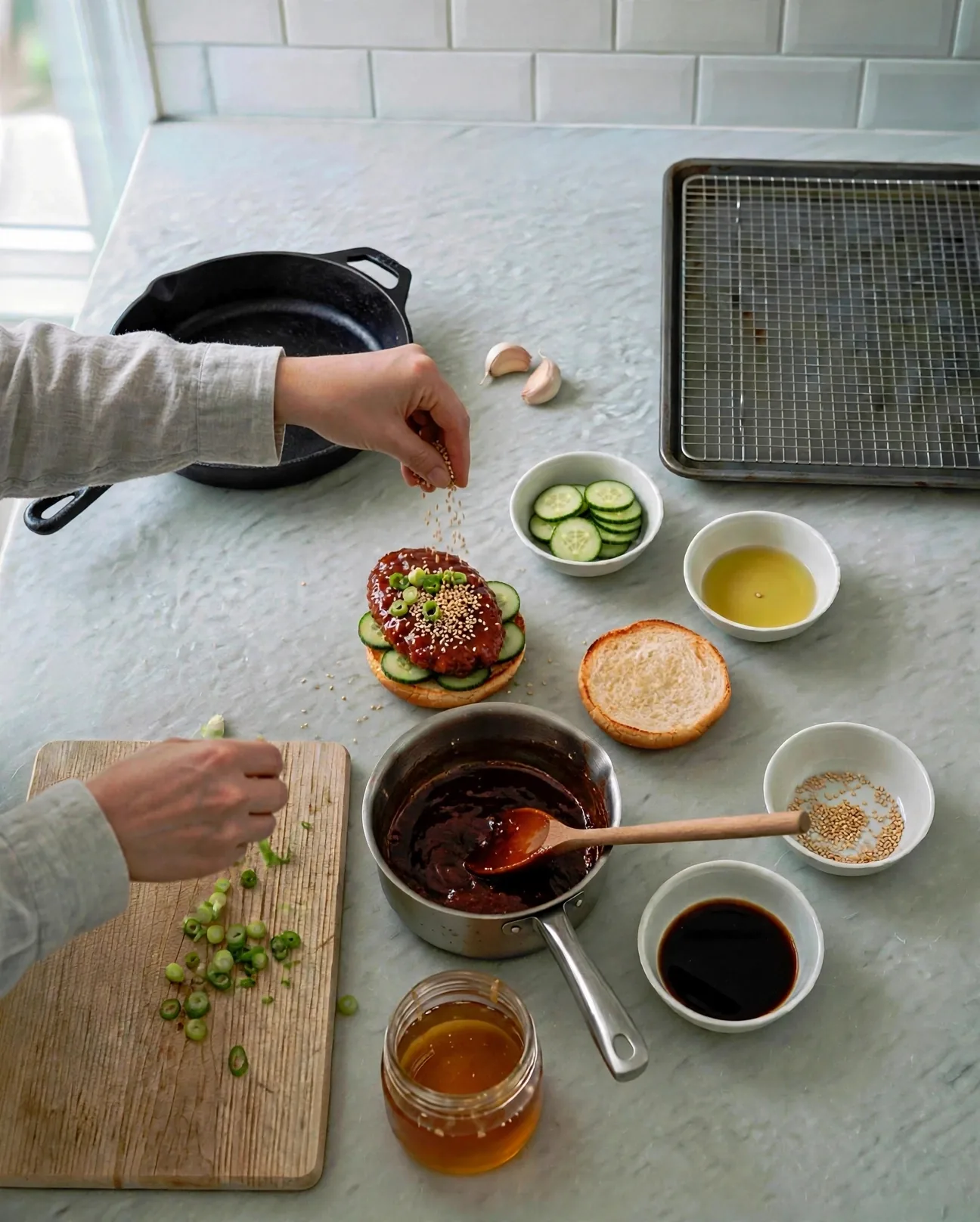 Topping a gochujang chicken sandwich with sesame seeds and green onion